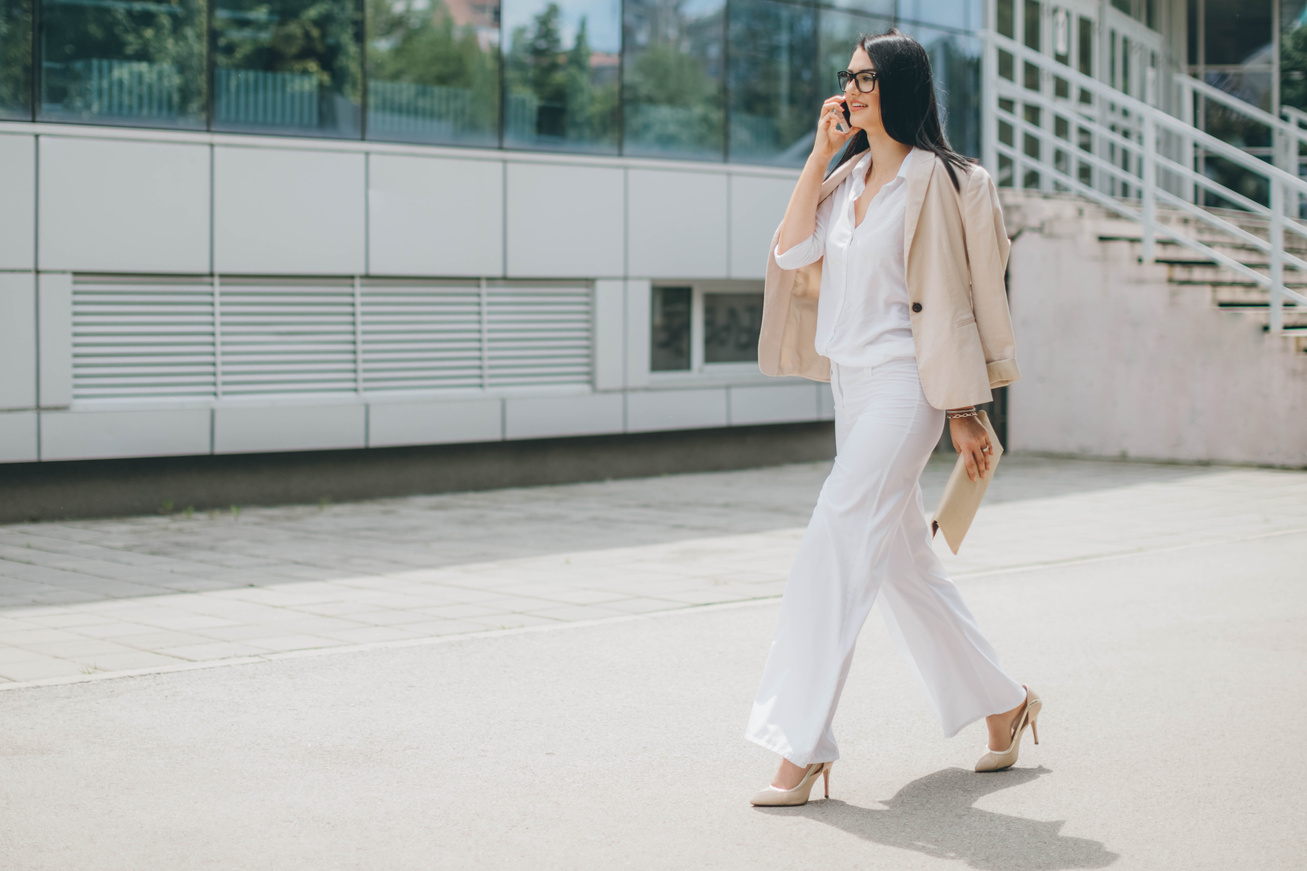 Business Women On Phone Walking In A Rush